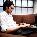 Picture of man using laptop for Facebook